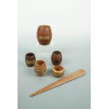 Match pots, a spill vase and paper knife carved from teak salvaged from historic British Navy ships