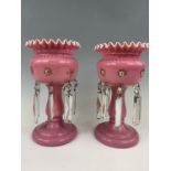 A pair of pink glass lustre's, 28 cm high
