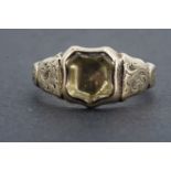 An early 19th Century signet ring, having a shield-shaped foil-backed matrix set between foliate-