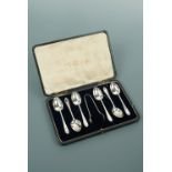 A cased set of six George V silver bead pattern tea spoons and sugar tongs, James Deakin and Sons,
