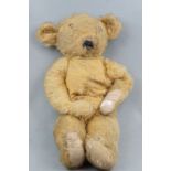 A large early 20th Century articulated golden plush Teddy bear, 65 cm