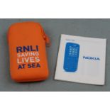 A Nokia 100 mobile phone and booklet