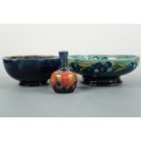 A Moorcroft Leaf and Berries pattern shallow footed bowl together with a Pomegranate pattern bowl