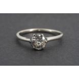 An antique .5 carat diamond solitaire ring, the brilliant cut stone crown set on a precious white