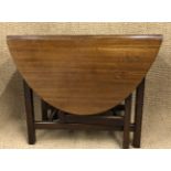 A mahogany oval gate leg dining table, 135 cm x 91 cm