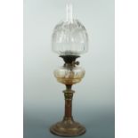 A Victorian columnar oil lamp with cut glass reservoir and etched glass shade