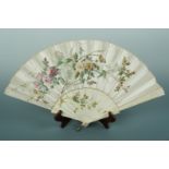 A Belle Epoque bone hand fan with champagne silk leaf, decorated with sprays of hand-painted British