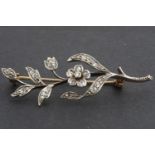 A Victorian diamond-set yellow metal brooch modelled as a floral sprig, set with old and rose cut