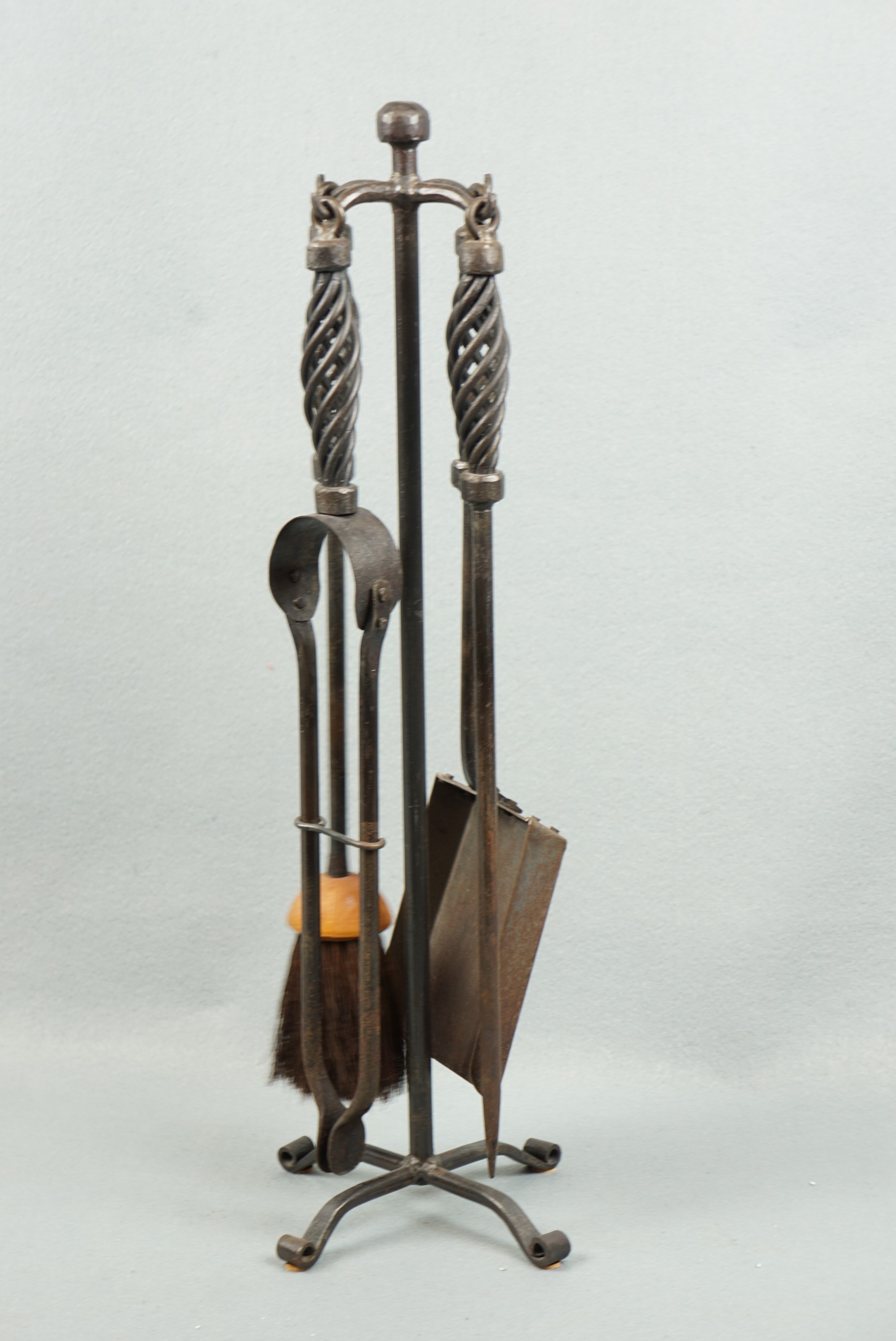 A wrought iron fireside companion set, 54 cm high