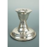A George V silver diminutive candle stick, with inverted bell-form socket and stepped circular foot,