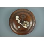 An early 20th Century Japanese carved and bone-inlaid wooden box, suspended from the underside of