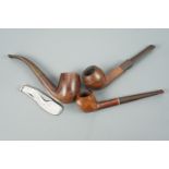 Three briar pipes and a pipe smoker's tool