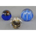 Three Caithness glass paperweights