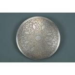 An Asian white metal powder compact, the front etched in a pattern of radiating lozenges on a