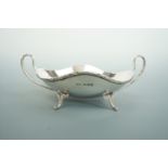 A George V silver bon bon dish, having an undulating rim with ribbon and reed border, a pair of