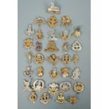 A large quantity of cap badges