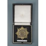 A German Third Reich Eastern peoples award, 1st class in gold with swords, cased