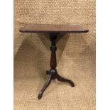 A Victorian mahogany tripod wine table with rounded oblong top
