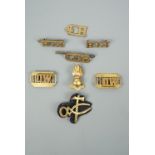 A small group of British army brass shoulder titles, a pioneer's qualification badge etc