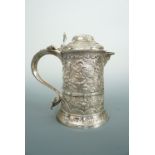 A George II silver lidded tankard, with Victorian profuse chased and engraved decoration depicting