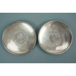 A pair of white metal prize coin dishes each centrally inset with a George II silver crown, engraved