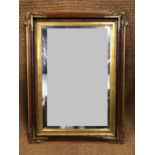 A large gilt-framed bevel-edged mirror, 70 x 97 cm