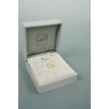 A Lalique crystal stud in the form of a leaf, gold plated, in original presentation box