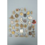 A large quantity of cap badges