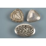 A small silver triangular-section pill box together with white metal reticulated and filigree boxes,