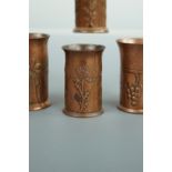 Four Keswick School of Industrial Art copper spill vases, each cylindrical with everted rim and