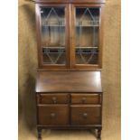 A George V leaded glazed mahogany bureau bookcase, 213 cm high