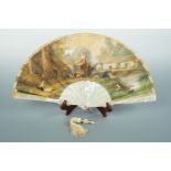 A 19th Century mother of pearl folding hand fan, with Realist influenced hand-tinted paper leaf, the