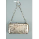 A George V silver ring purse, of rounded rectangular form, engraved with a scrolling spray of
