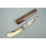 An antique ethnic dagger having an ivory "pistol" grip and double-fullered, subtly curved single-