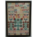 A Victorian needlework alphabet sampler by Alice Hutchinson aged 9, wool threads over aida, framed
