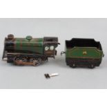 A vintage Hornby tinplate clockwork 0-gauge railway locomotive and tender in British Railways