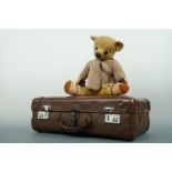 A vintage Teddy bear, having blonde mohair, glass eyes, articulated limbs and wood wool filling,