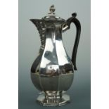 An Edwardian silver coffee pot, of faceted baluster form, with acanthus faced spout and flaming