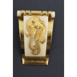A 1930s Jean Painlevé Art Deco sea horse or L'Hippocampe clip brooch, in gilt metal and Bakelite,