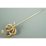 A Victorian yellow metal stick pin, its terminal in the form of an open knot, 9.5 cm, 6.2 g