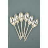 A set of six Elizabeth II silver novelty golf coffee spoons, the stems modelled as an adorsed pair