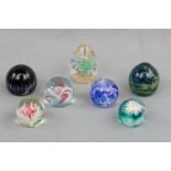Seven small paperweights