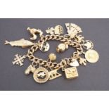 A 9ct gold charm bracelet and charms, 87.7g