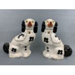 A pair of Staffordshire black and white spaniels