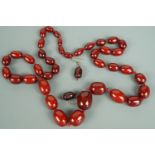 A vintage cherry amber coloured bead necklace and ear pendants