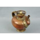 An antique Tibetan copper and brass teapot, 20 cm