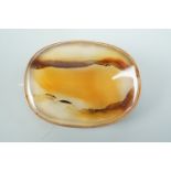 A late 19th / early 20th Century yellow metal mounted agate cabochon brooch, 30 mm x 23 mm