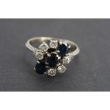 A vintage precious white metal, diamond and sapphire dress ring, comprising three oval-cut sapphires