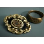 A Victorian mourning locket brooch together with an antique brass finger ring naively engraved