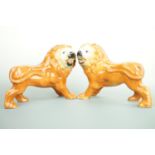 A 19th Century pair of Bo'ness type hearth lions, with inset glass eyes, 27 cm